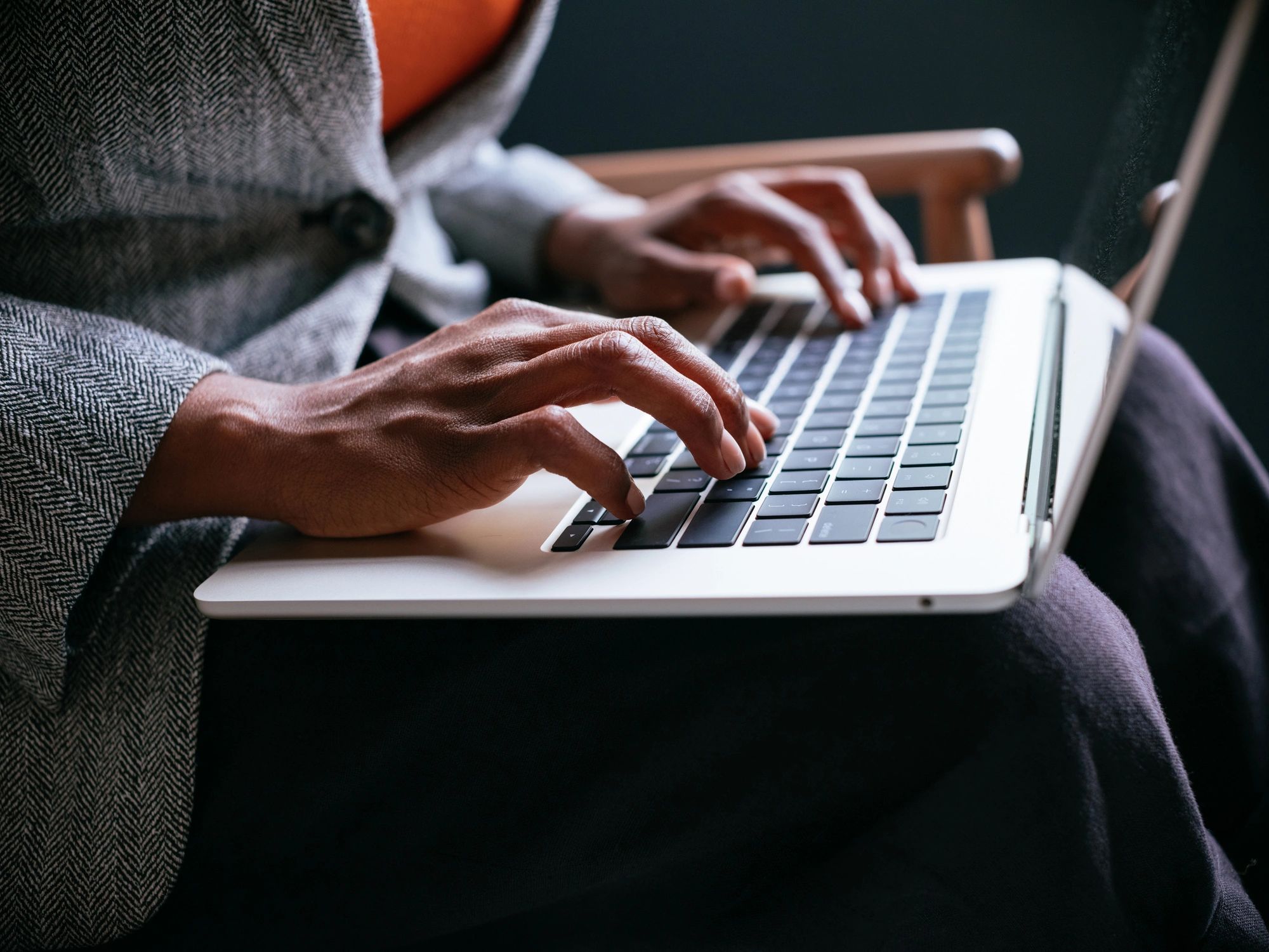 Professional using a laptop in a secure workspace